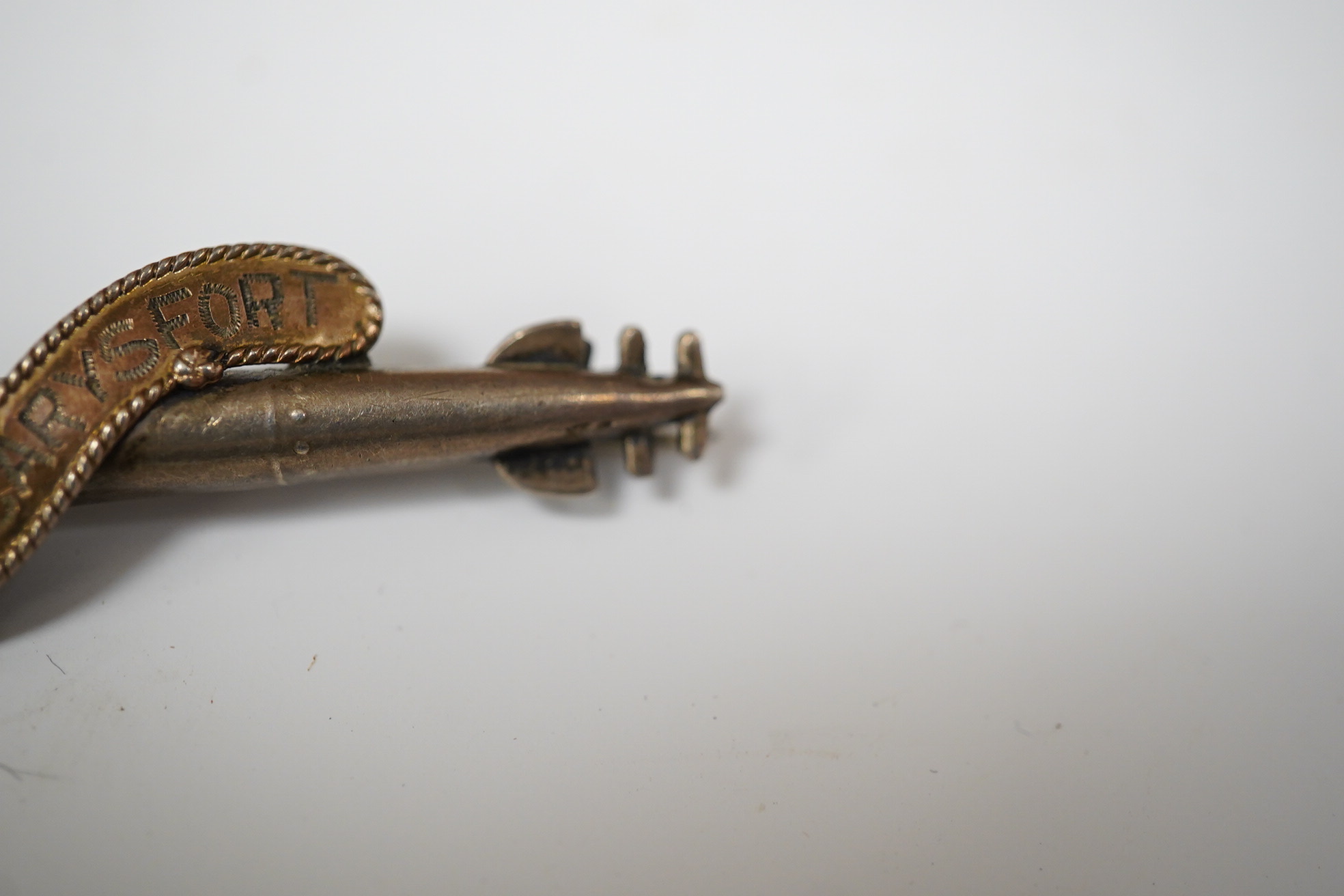 A WW1 silver sweethearts brooch from HMS Caryfort modelled as a torpedo